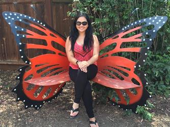 Mrs. Ballesteros sitting on a butterfly bench