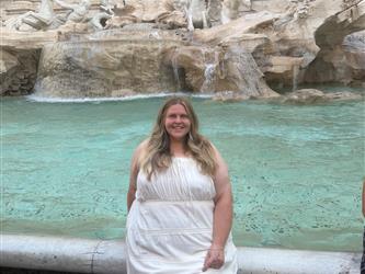 girl sitting in front of fountain