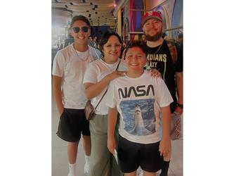 A man, woman, and two young boys smiling for a selfie